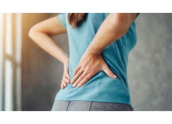 Lady Holding Hands Behind Back Due to Back Pain